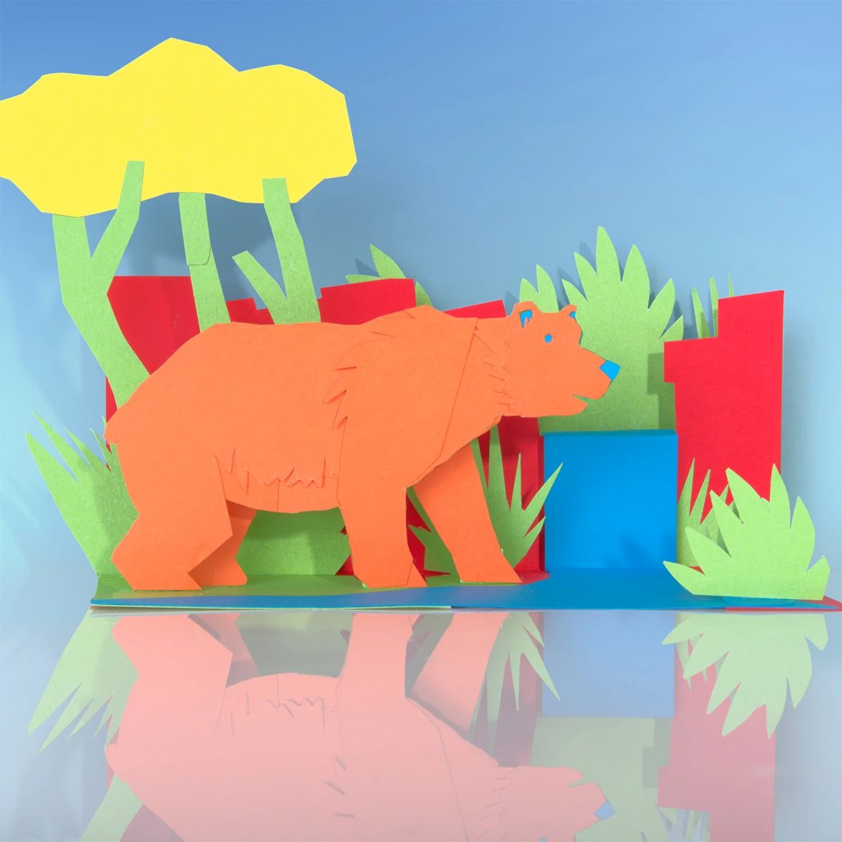 Bear and forest scene made from colored card.