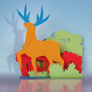 Paper cut stag made from sheets of colored card.